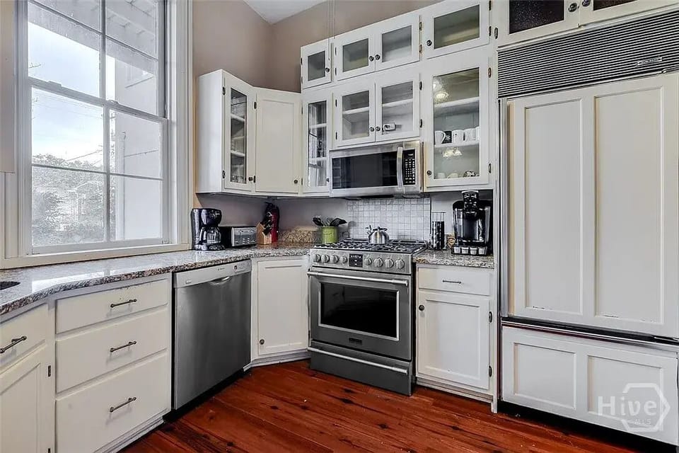 Large gas range and Sub-Zero fridge