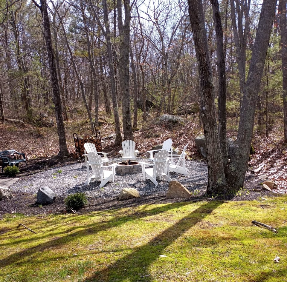 New firepit with Pollywood Adirondack chairs. Large granite slabs add extra seat
