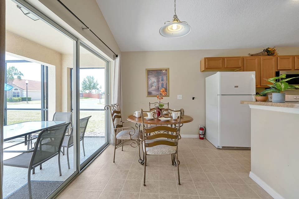 Breakfast table leads to the outdoor patio and pool