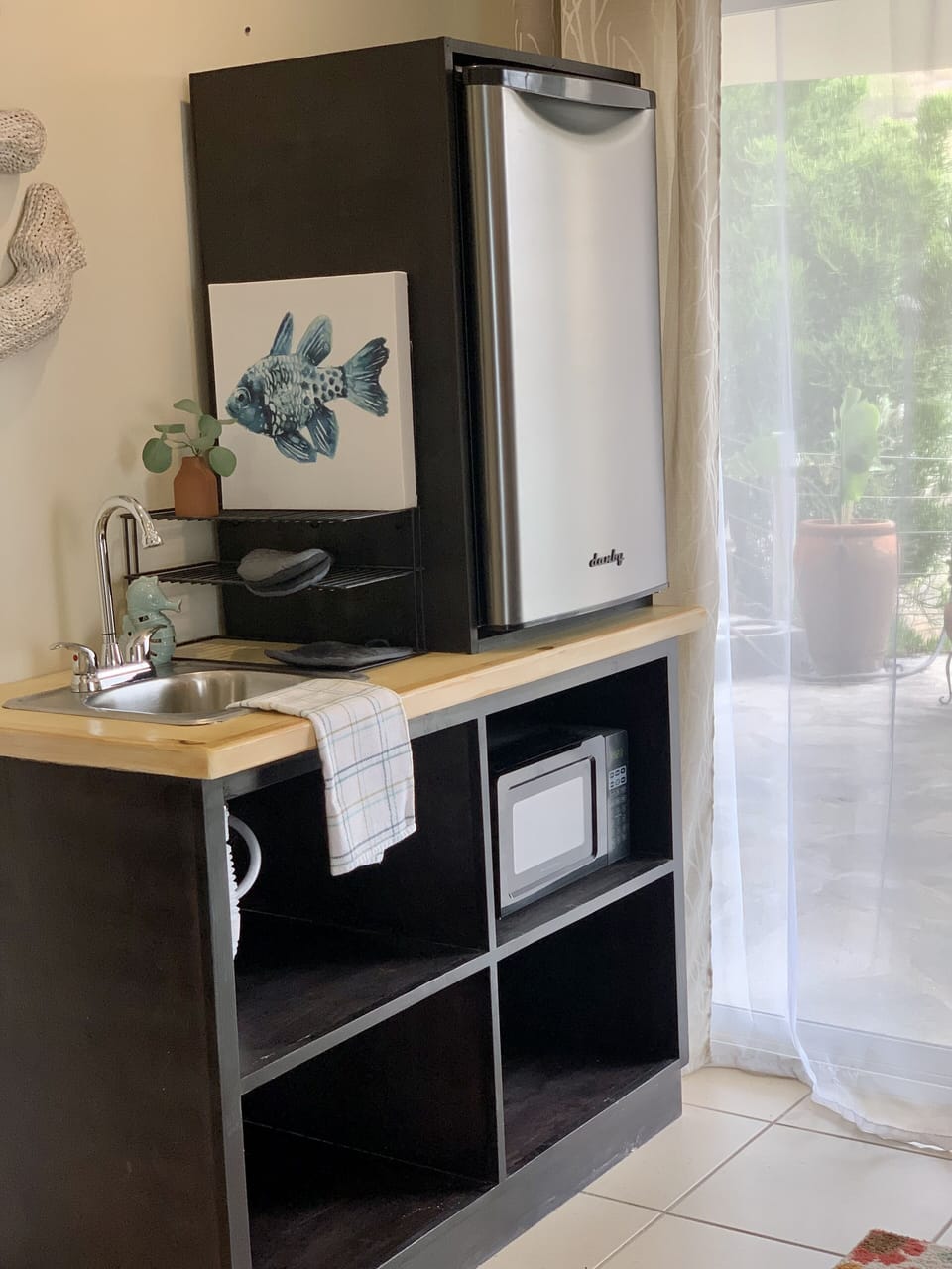 Kitchenette sink and mini fridge area 