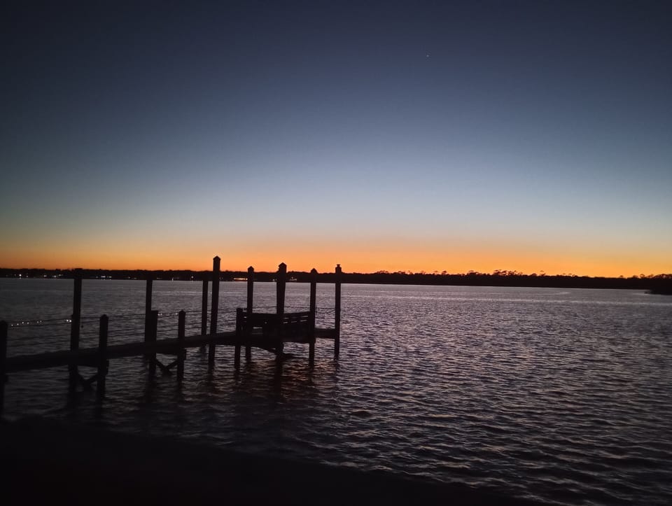 sunset at a river dock at the end of the street
