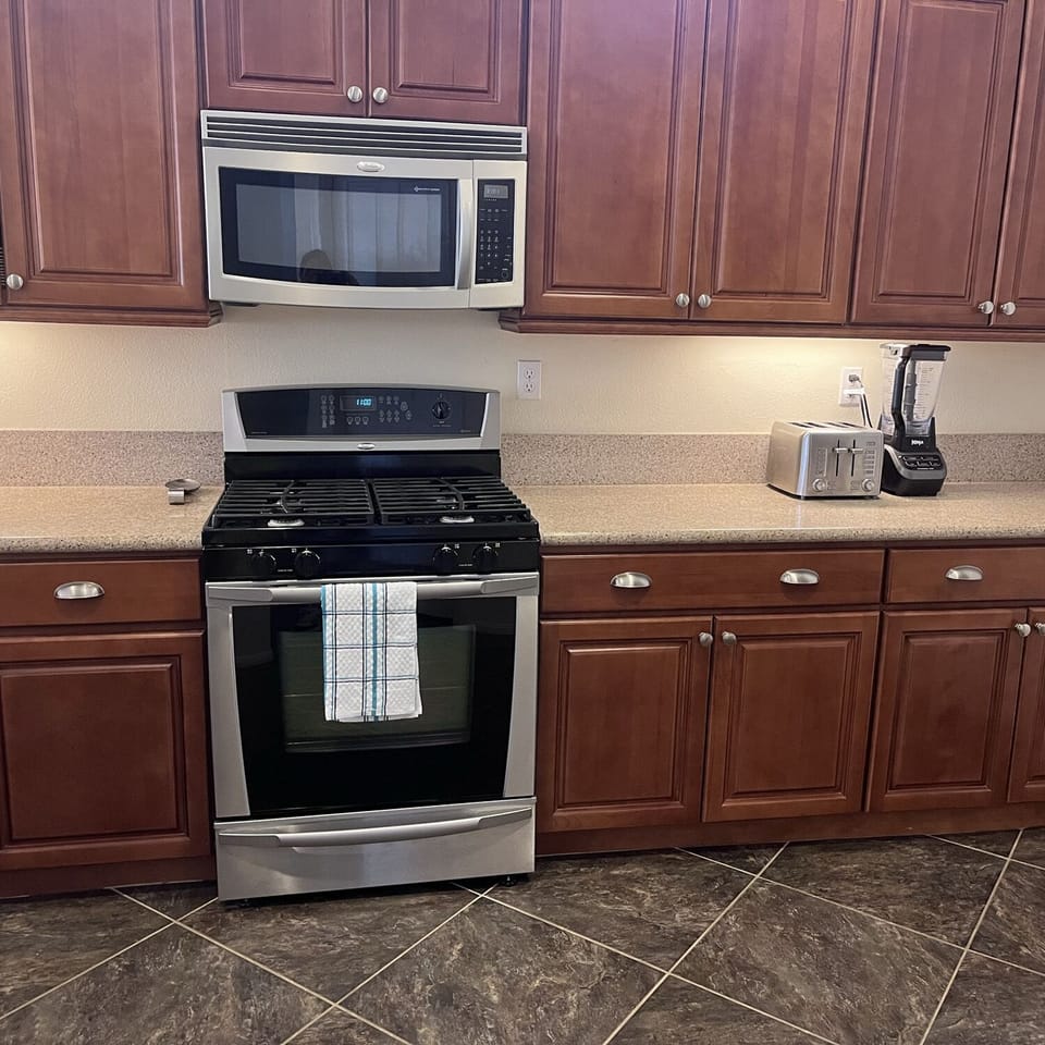 Kitchen includes oven, stove, microwave, dishwasher, full-size refrigerator