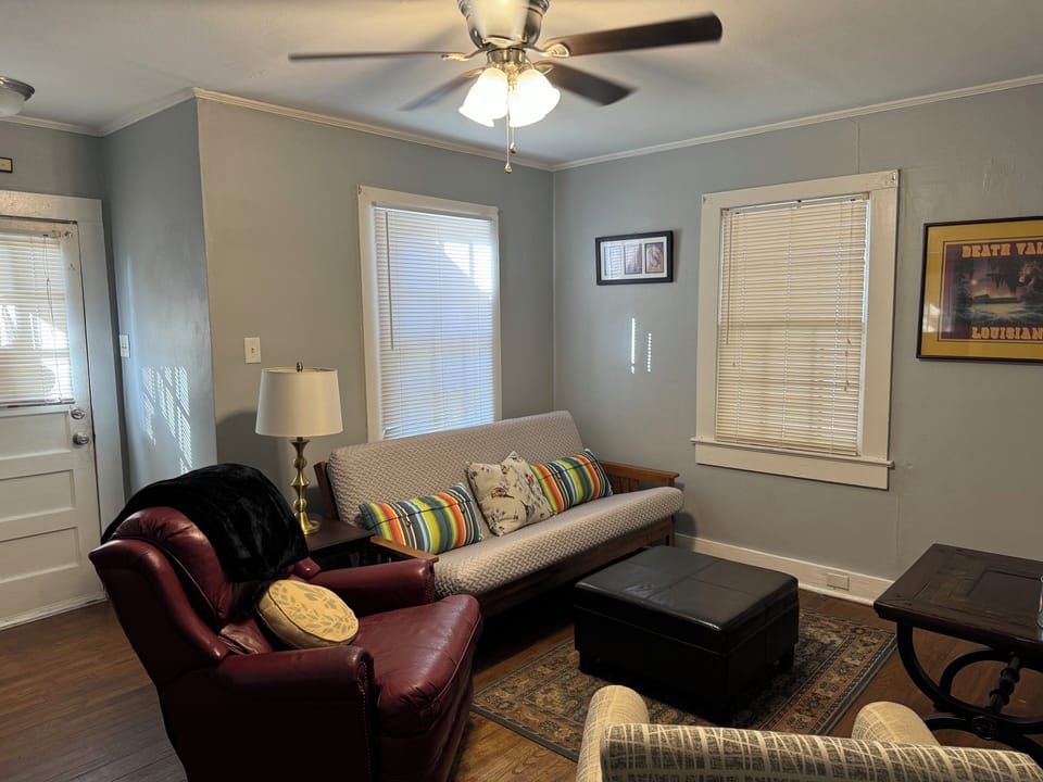 Living room with futon, recliner, chair, and TV