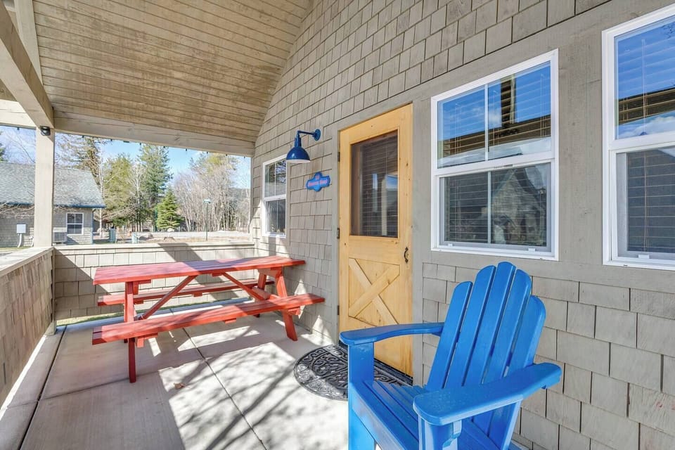 The bungalow patio features a picnic table, two chairs and a BBQ.