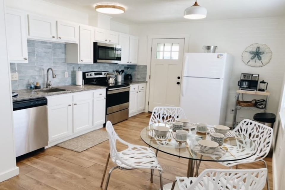 Kitchen with dining for 4 and access to back deck and outdoor shower