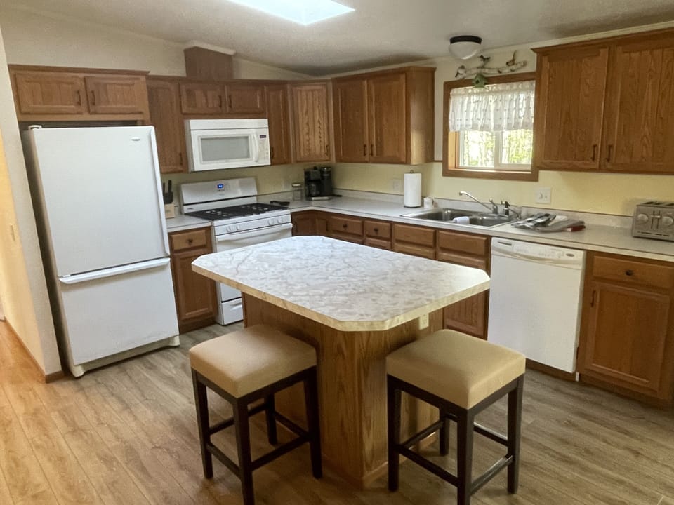 Full amenity kitchen with a coffee maker and dishwasher 