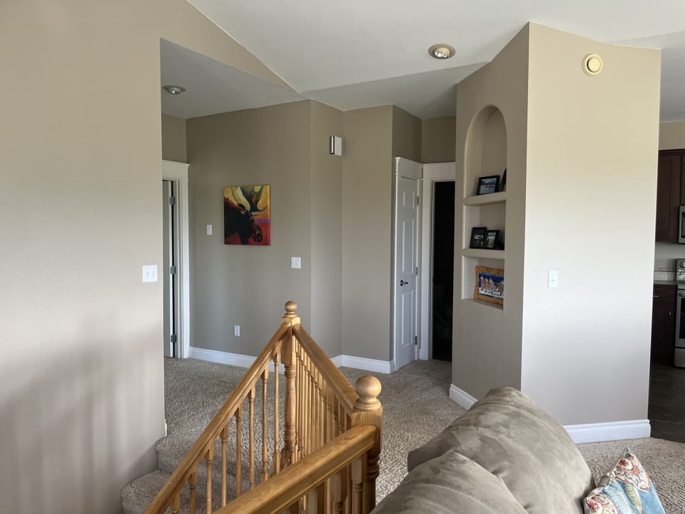 Upstairs hallway with bathroom between bedrooms and kitchen/living rooms.