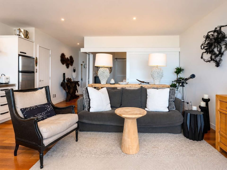 Living and dining area with sea views across Onetangi Bay