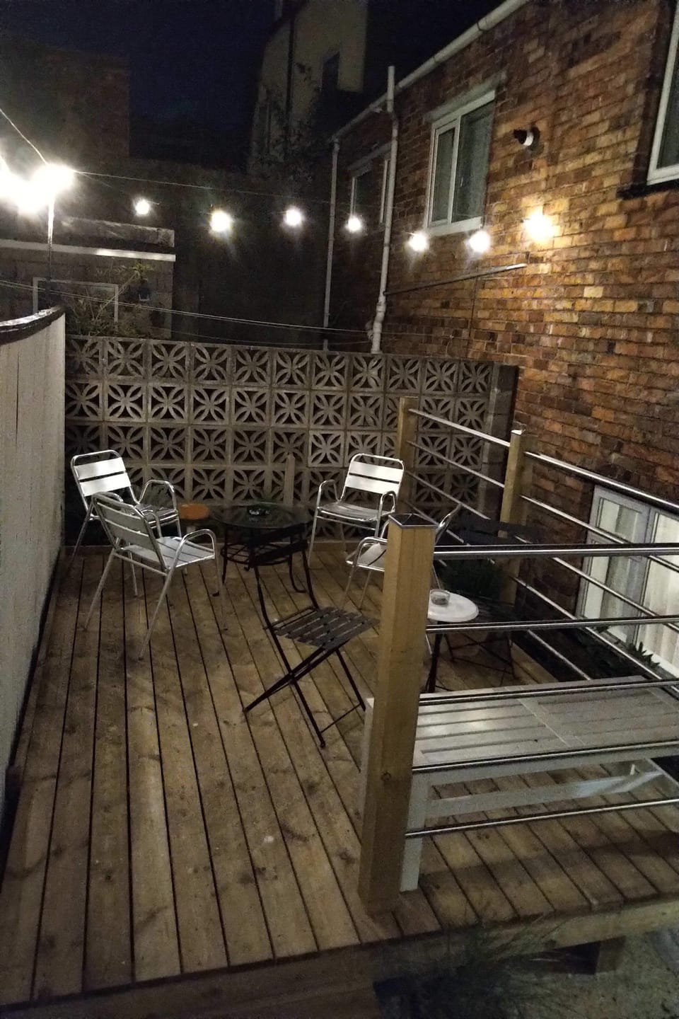 Decking with railings in the rear courtyard
