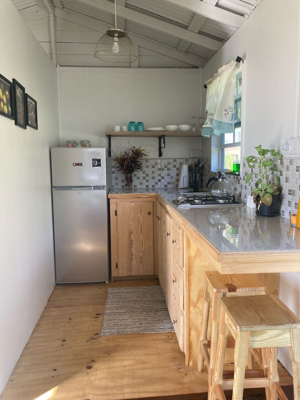 Kitchen has fridge, 2 burner stove, coffeemaker, kettle, pots & pans,  utensils 