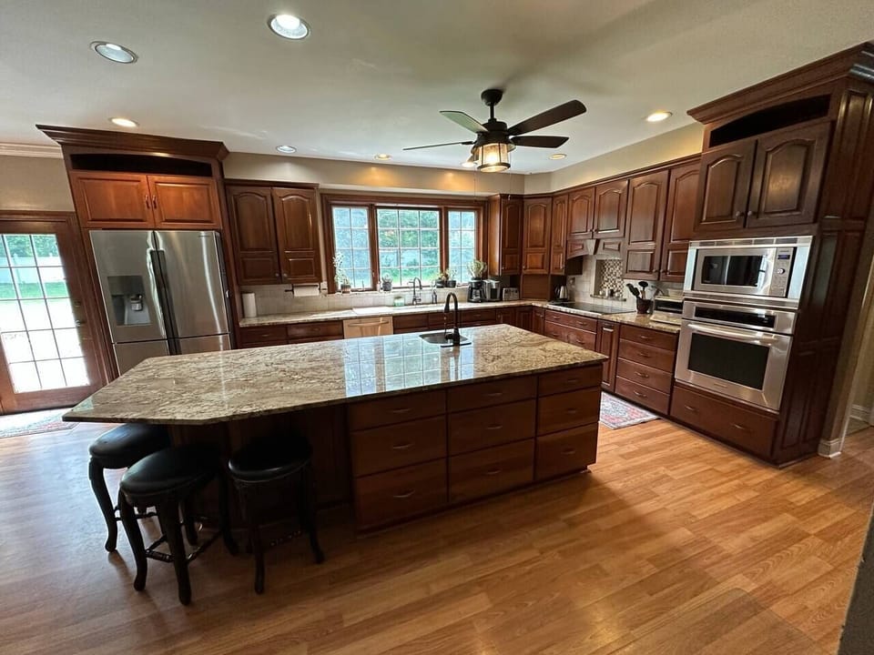 Kitchen with 9 ft ceilings, top quality appliances, 2 sinks, large island, lots of lighting and cabinet space
