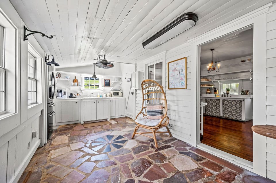 Sunroom as you enter from the driveway. Well lit by the natural light pouring in