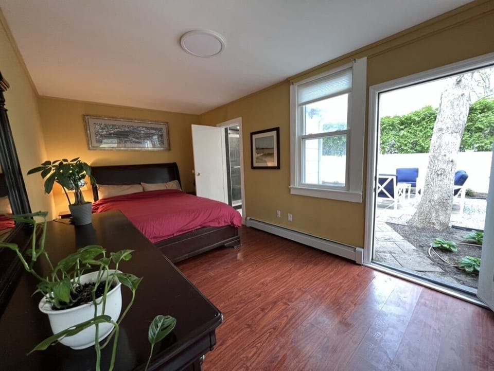 Bedroom, bathroom door at right, back door open. 