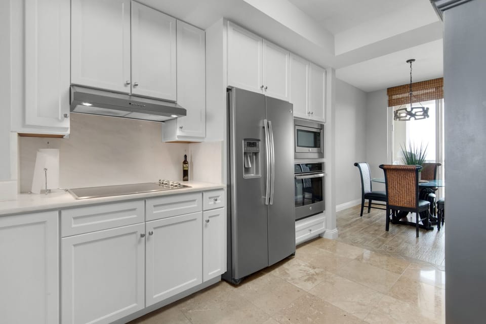 Splendid white cabinets, with complimenting white counters and slate appliances
