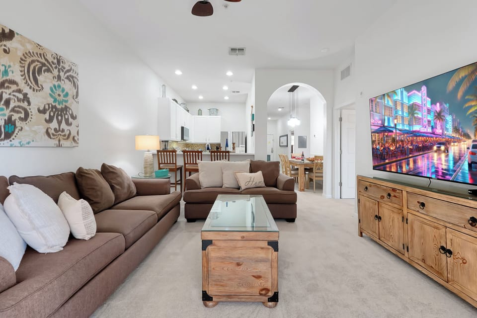 Open space living room with kitchen in background