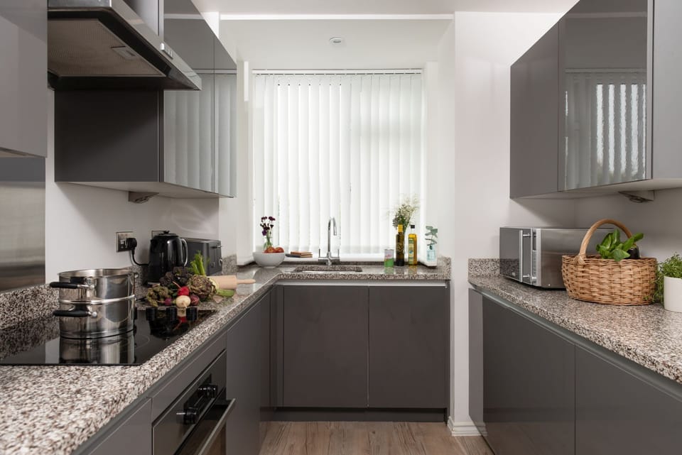 Kitchen with dishwasher, microwave, kettle, toaster, and washing machine -  Kingsley House