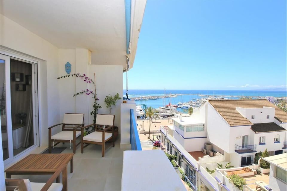 Side view of the balcony with outdoor seating area and sea views