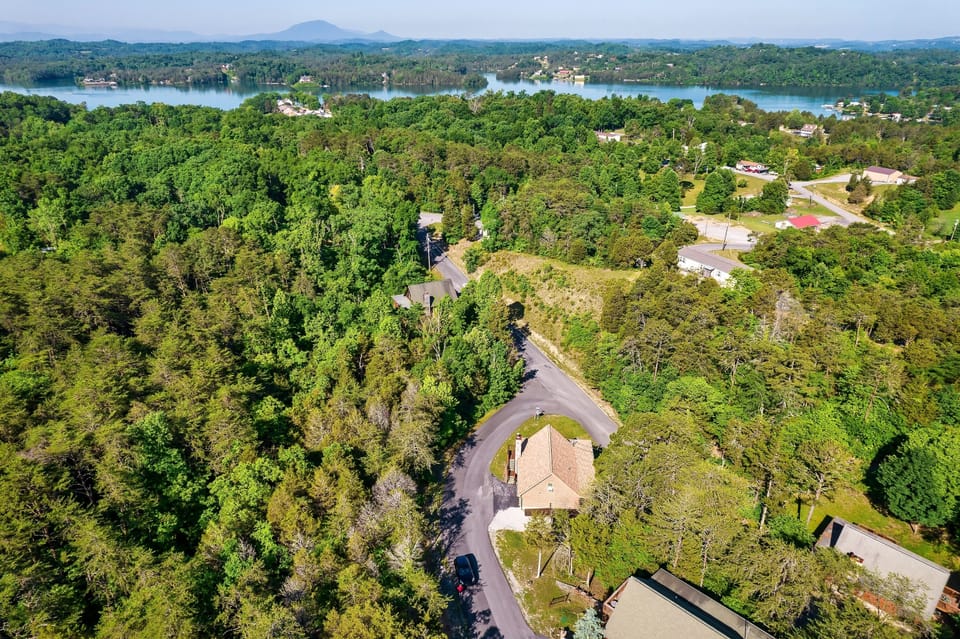 View of the cabin in proximity to lake.