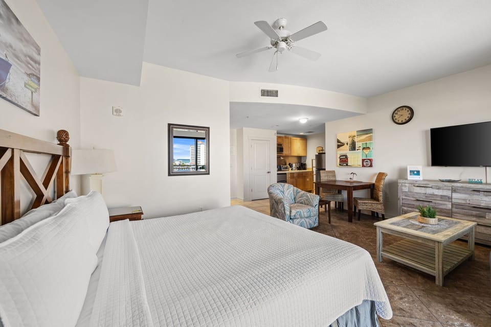 Step into your bright, open suite where coastal charm meets comfort. Relax in your cozy bed, unwind in the sitting area, or prepare snacks in your kitchenette—all under a gentle ceiling fan.