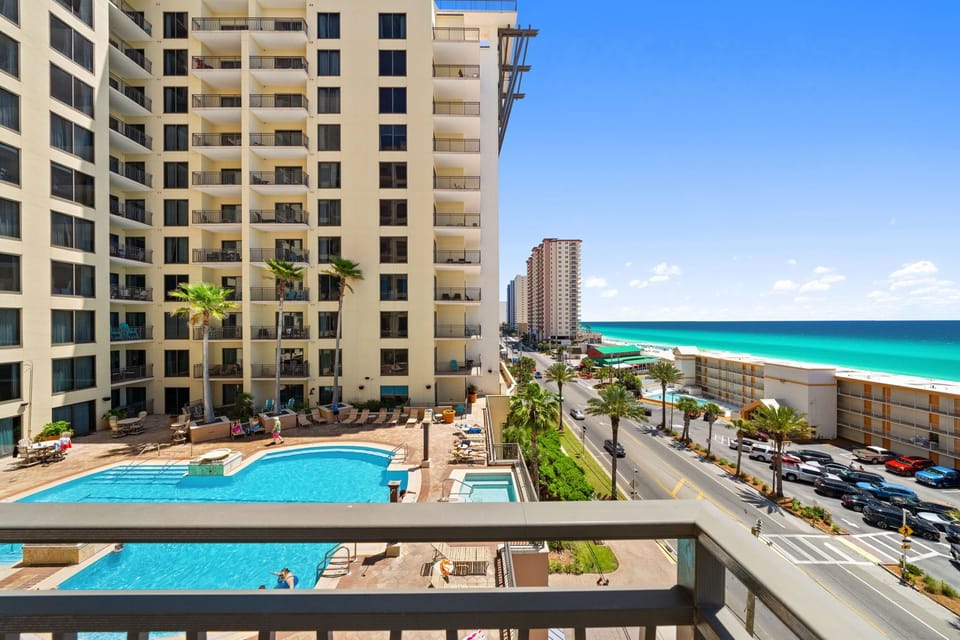Beachfront property offers stunning ocean views with pool access and tropical surroundings in this coastal destination.