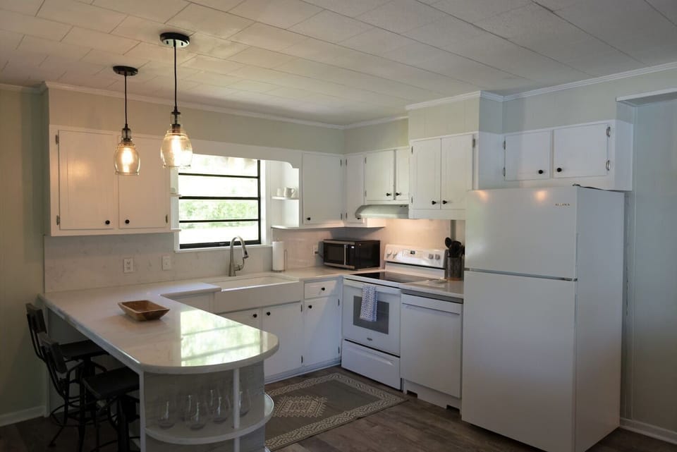 Fully equipped kitchen, pots, pans, dishes with open concept to living room!