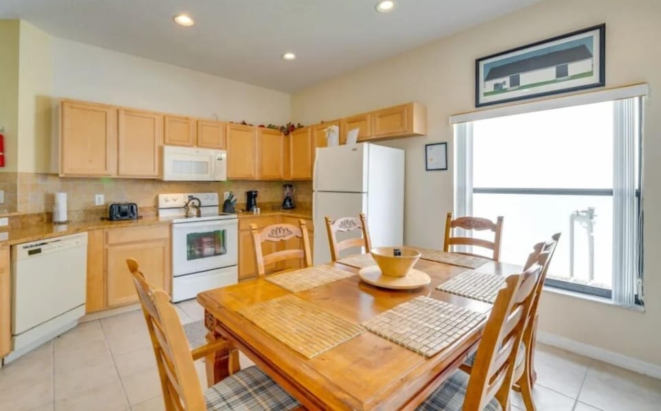 Kitchen showing dining room table and large picture window
