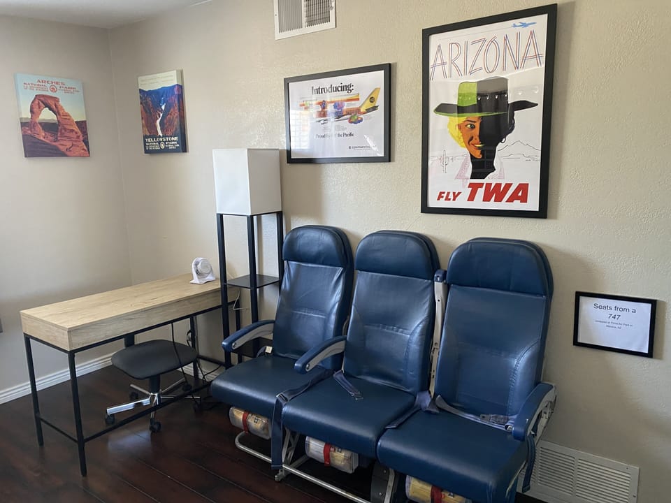 The travel themed third bedroom with airplane seats!