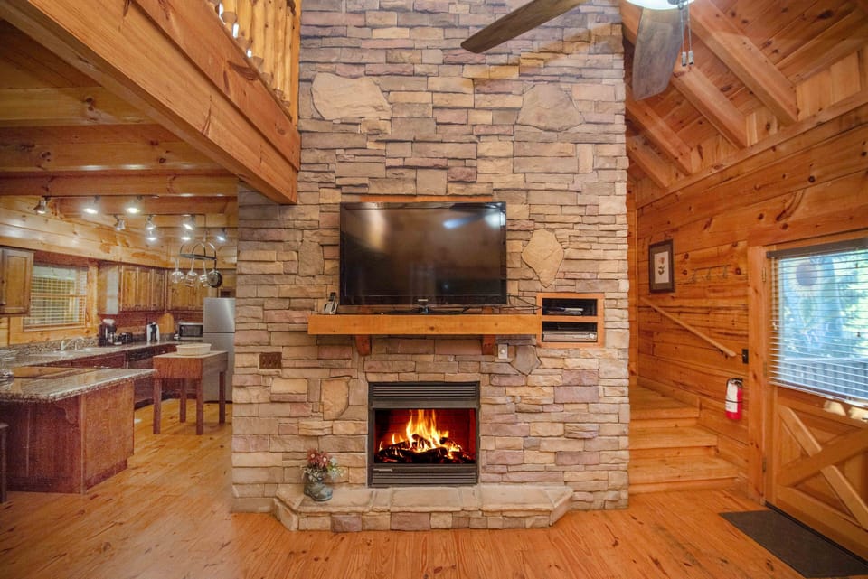 Beautiful fireplace, stacked stone to the ceiling, greets you at the front door.