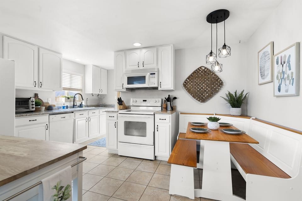 Kitchen Nook: Bright and inviting space with modern appliances and charming dining seating!