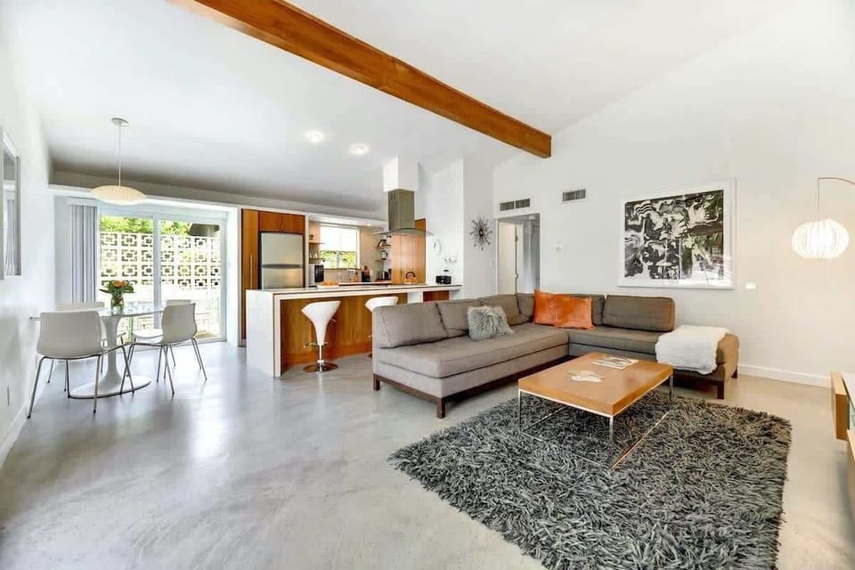 The living room features a comfy sectional sofa and ROKU TV