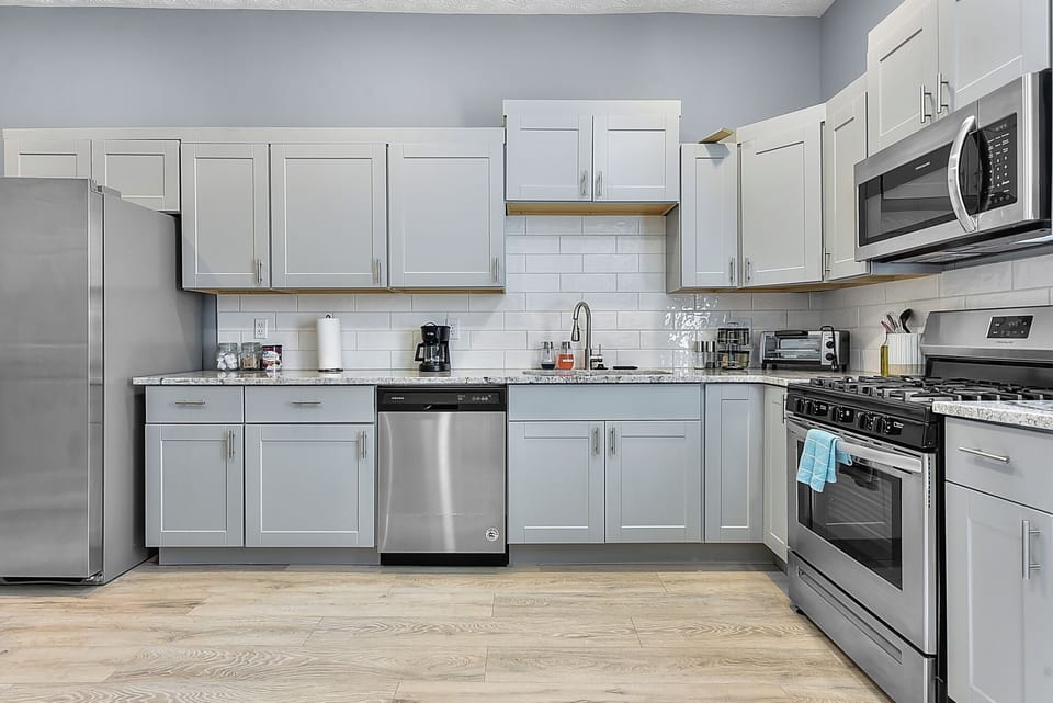 Kitchen With Stove Microwave, Toaster, and Dishwasher