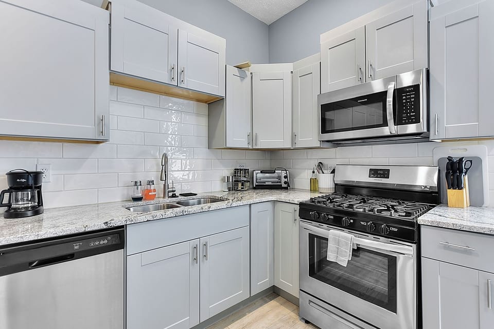 Kitchen With Stove Microwave, Toaster, and Dishwasher