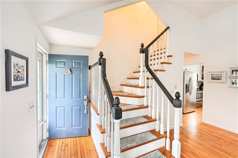 Follow the staircase to upper level which is entirely occupied by the Primary bedroom suite - 671 Great Fields Rd Brewster Cape Cod - Beach Glass - New England Vacation Rentals