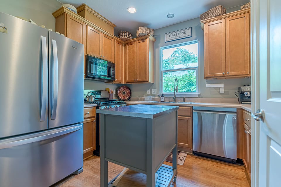 Kitchen includes gas stove, espresso machine, coffee maker, microwave 