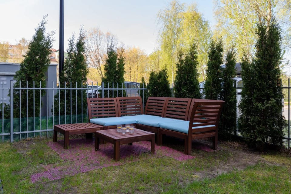  A close-up of an outdoor dining area with wooden furniture, perfect for enjoying meals outdoors.