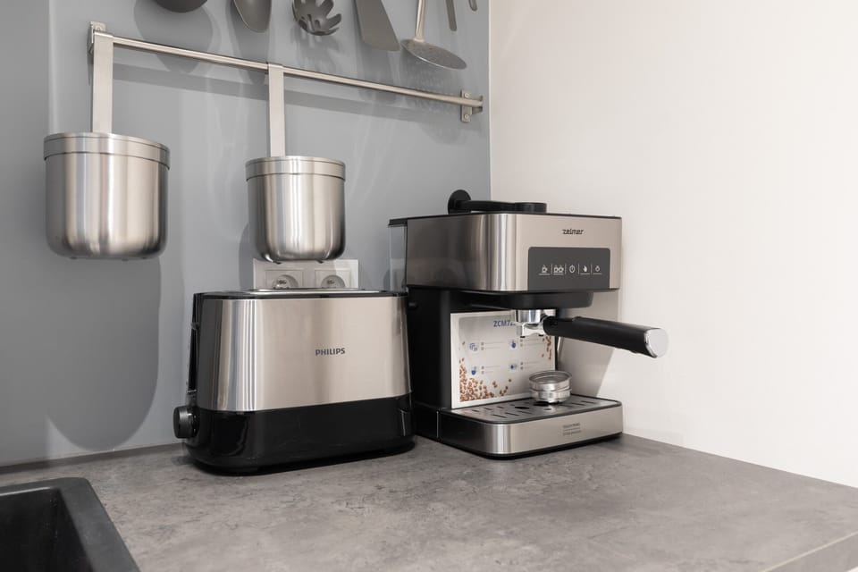 Kitchenette with toaster, electric kettle and coffee machine.