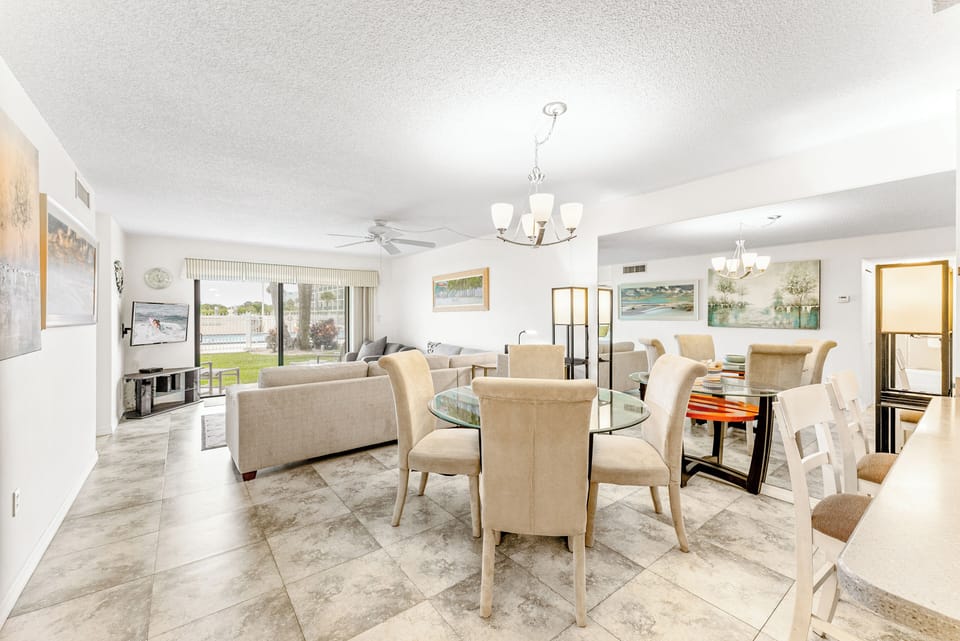 Elegant dining area seats four with open-concept living and natural light.