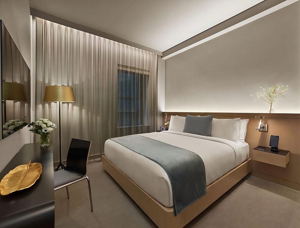 Sink into crisp linens beneath soft, calming ambient glow.