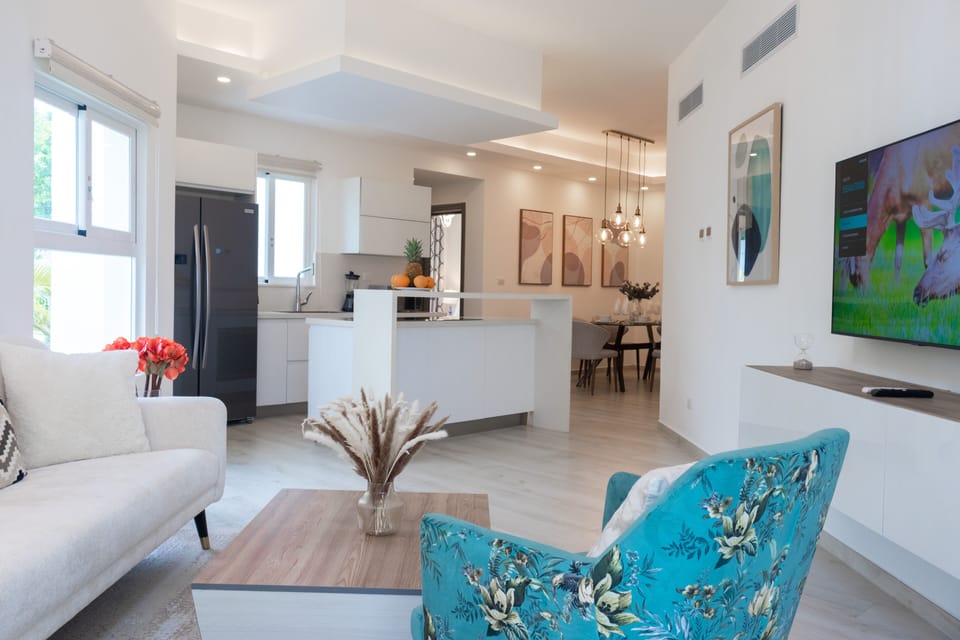 Bright and spacious living room with comfortable sofa and big-screen TV