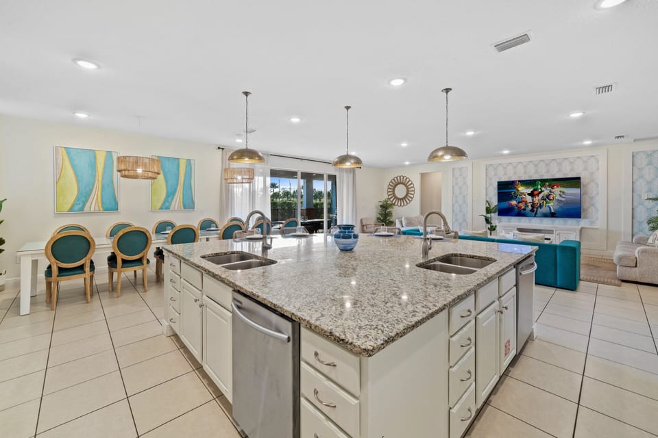 - Open kitchen with large island and double sinks  
- Dining table seats the entire group in modern style  
- Spacious layout connecting kitchen and living area