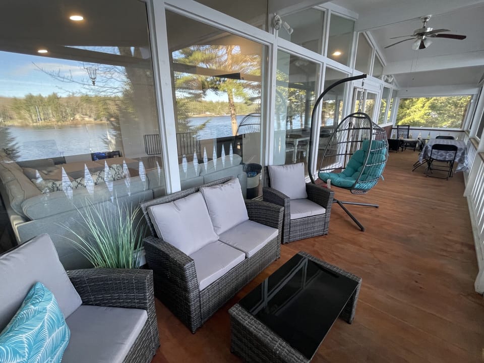 expansive screened-in porch | comfortable seating & dining area overlooking lake