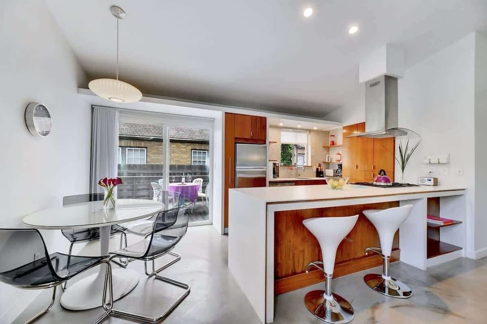 There's seating for 4 at the dining table, 2 at the kitchend island and 4 outside.