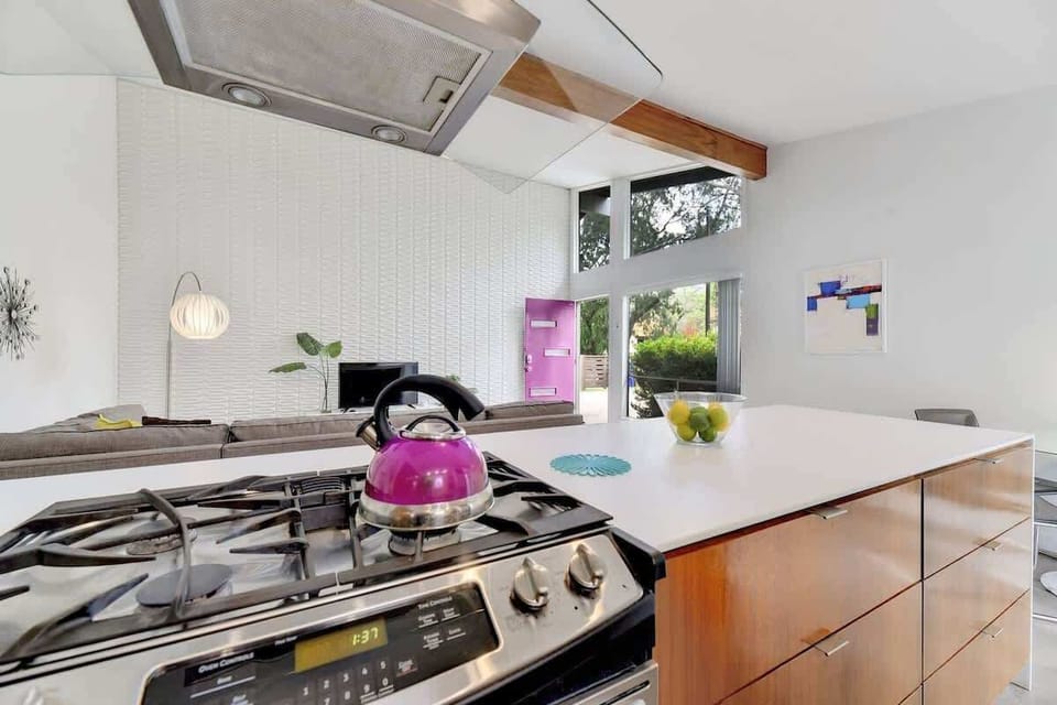Kitchen with Stainless Appliances, Dishes, and Cookware.