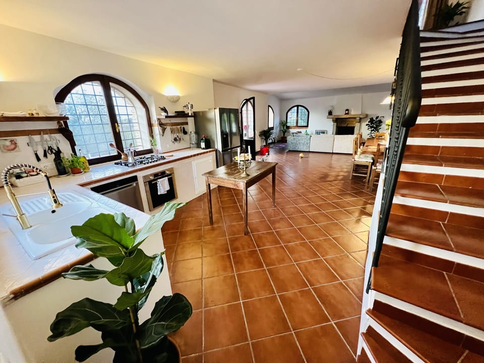 The main villa's kitchen and dining table and living room area