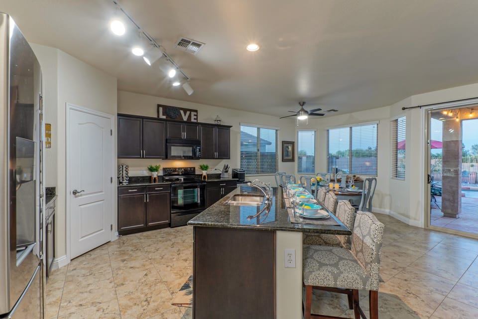 Kitchen is part of large and spacious great room that overlooks the backyard paradise.