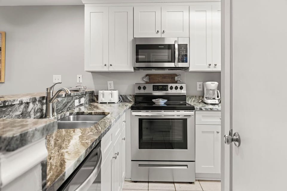 Kitchen - The spacious kitchen features stainless appliances and is fully stocked with all items needed for preparing meals during your stay.