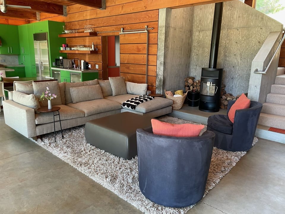 Another view of the living room with barn door to laundry room and powder room