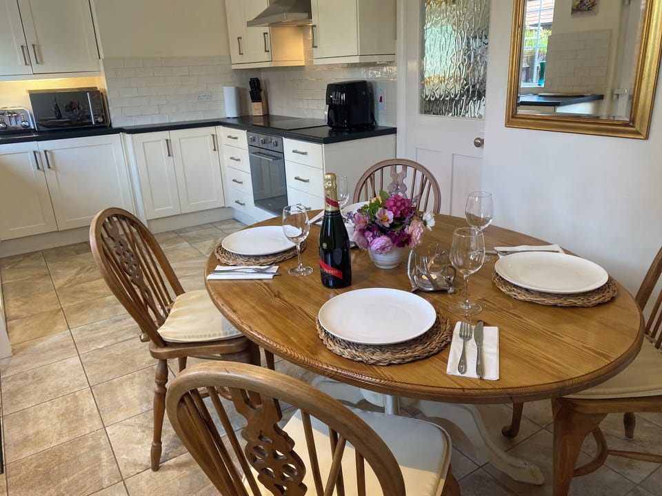 Enjoy dining at the traditional farmhouse table and chairs.