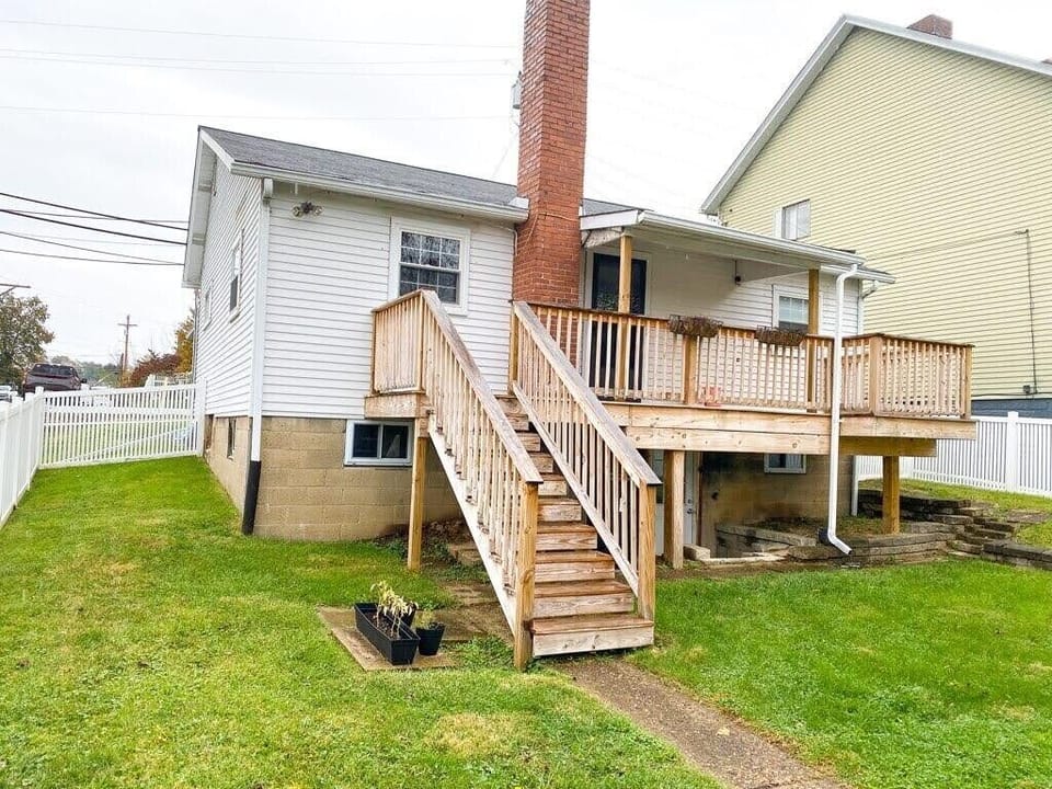 Fenced in backyard with spacious deck.