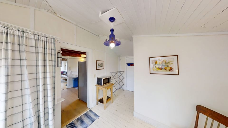 Off of the kitchen area is a half bath and sitting area.